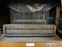 Interior of the organ at Cradley Heath Baptist Church showing the tracker action.  The black rods, called rollers, rotate to transmit movement sideways to line up with the pipes.