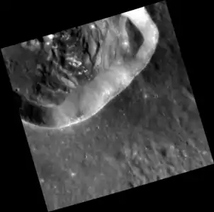 Part of the small, prominent crater within Hafiz crater that is a dark spot with hollows