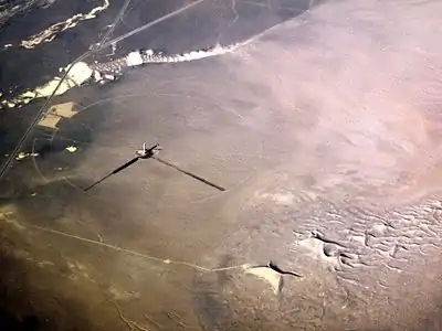 2012 January – The solar tower under construction as seen from a commercial airliner. The titular Crescent Dunes are at lower right.