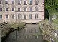 The culvert carrying the Bonsall Brook under the mill extension