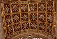 The carved, painted and gilded barrel-vaulted ceiling