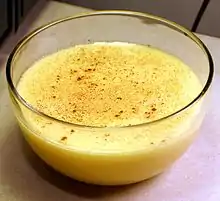 A bowl of crème anglaise custard, dusted with nutmeg