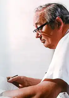 Office portrait, D. Jamison Cain reviewing typewritten writing in his office at US Postal Service Headquarters, L'Enfant Plaza, Washington DC, ca 1980