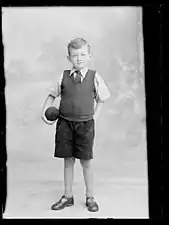 Studio photograph of a seven-year-old boy wearing T-bar sandals in Strabane, Northern Ireland, 1915.