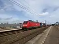 A freight train from DB Cargo Scandinavia passing Trekroner Station.