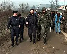 Local policemen and US military personnel on their way to check a post-Dayton resettlement effort