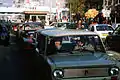 East Germans drive their vehicles through Checkpoint Charlie as they take advantage of relaxed travel restrictions to visit West Germany. The car is Lada 2102.