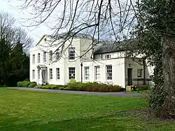 White plaster building surrounded by trees