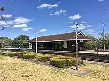 Railway platform with brick building