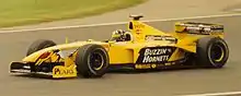 Damon Hill driving the Jordan 199 at the 1999 British Grand Prix with "Buzzing Hornets" livery.