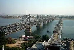 The current Sino-Korean Friendship Bridge next to the ruins of the old bridge