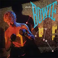 A shirtless man wearing boxing gloves preparing to box. The giant word "Bowie" appears with "Let's Dance" spelled out through connect-the-dots