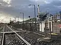 Westbound view in November 2022, with works for the station rebuilding and level crossing removal in the background.