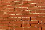 Defective pointing can allow rain to penetrate through masonry walls.