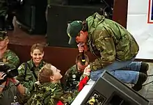 Shane Minor singing to a US soldier at Tuzla Air Base, Bosnia and Herzegovina, in 1999.