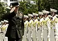 General Peter Pace inspecting the company dressed in its white full dress uniform.