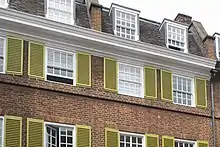 Image of the exterior of Delfina Foundation - an Edwardian town house, with green shutters.