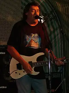 Stratton performing with Praying Mantis, with a T-shirt depicting artwork from Forever in Time