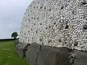 The retaining wall and kerbstones.