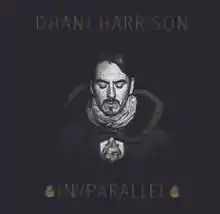 A black-haired, Caucasian man's face on a black background. All text on the cover is gold. Above his head are the words "DHANI HARRISON," and below reads "IN///PARALLEL," surrounded by what appear to be two pine cones.