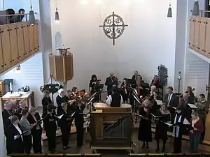 A choir with instrumentalists, in historic layout