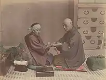 Image 45A doctor checks a patient's pulse in Meiji-era Japan. (from History of medicine)