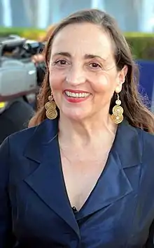 Dominique Blanc at the 2017 Deauville American Film Festival facing to the front, wearing a dark blue coat and smiling