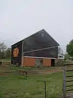 Donkeys graze outside this barn on Shadyside Avenue