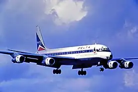 Douglas DC-8 aircraft in flight against a blue sky