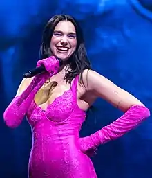 Dua Lipa smiling on stage