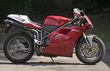 A red motorcycle parked on a street.