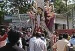 Durga Puja at Chittaranjan Park Kali Mandir (2004): the large durga idol is physically lifted onto a truck while devotees offer their tearful goodbyes.