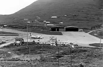 View of Dutch Harbour ramp area with a USCG C-130 Hercules on stand-by for an emergency flight.