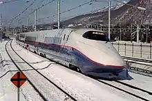 A Nagano Shinkansen E2 series "J" set approaching Karuizawa, February 1998