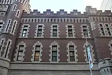 Windows on the First Battery Armory's upper stories. The windows are surrounded by granite trim, and the rest of the facade is made of brick.