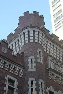 Detail of the top of the central tower, which contains a parapet with openings