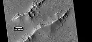 Layers and dark slope streaks in Lycus Sulci, as seen by HiRISE under HiWish program