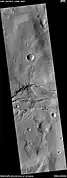 Channel cutting across trough, as seen by HiRISE under HiWish program The trough and channel are labeled.