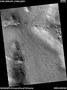 Lineated valley fill in valley, as seen by HiRISE under HiWish program Linear valley flow is ice covered by debris.