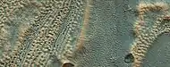 Close, color view of ice layers in crater in previous image, as seen by HiRISE under HiWish program  Both, open and closed brain terrain are visible.