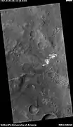 Contact showing light and dark-toned materials,  as seen by HiRISE under HiWish program  Light-toned materials typically contain water in minerals.