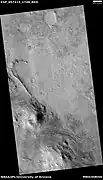 This straight ridge may be a dike that has been exposed by erosion.  It was initially formed by magma moving under the surface along weak spots.  The picture was taken with HiRISE under the HiWish program.