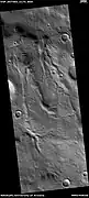 Channels, as seen by HiRISE under HiWish program  These channels are near the ejecta of a crater; hence, they may have formed from warm ejecta melting ground ice.