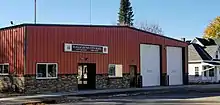 One story brick and wood building with a sign reading "Eagle Bend City Hall, city offices, fire department".