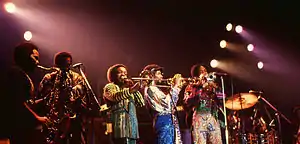 The Phenix Horns in 1982. (L–R): unknown, Don Myrick on saxophone, Louis Satterfield on trombone, Michael Harris on trumpet, and Rahmlee Michael Davis, also on trumpet.