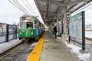 A light rail train at a platform