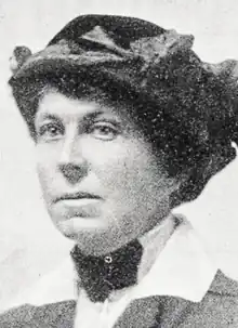 Photograph of a white woman wearing a dark hat; from a 1918 newspaper.