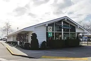 A building with a slanted roof and large windows