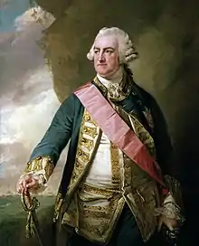 a ruddy-faced man wearing a horse-hair wig and a resplendent naval uniform