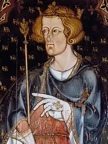 A pale, brown-haired man holding a sceptre and wearing a crown. He is clothed in a black and robe over a white shirt, and is wearing pale gloves